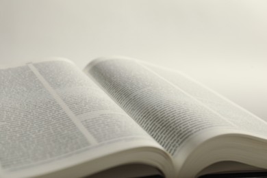 Open Holy Bible in English language on white background, closeup