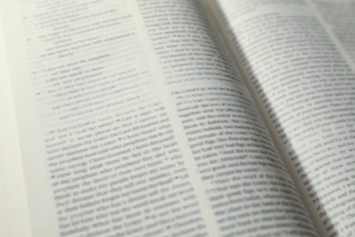 Photo of Open Holy Bible in English language as background, closeup