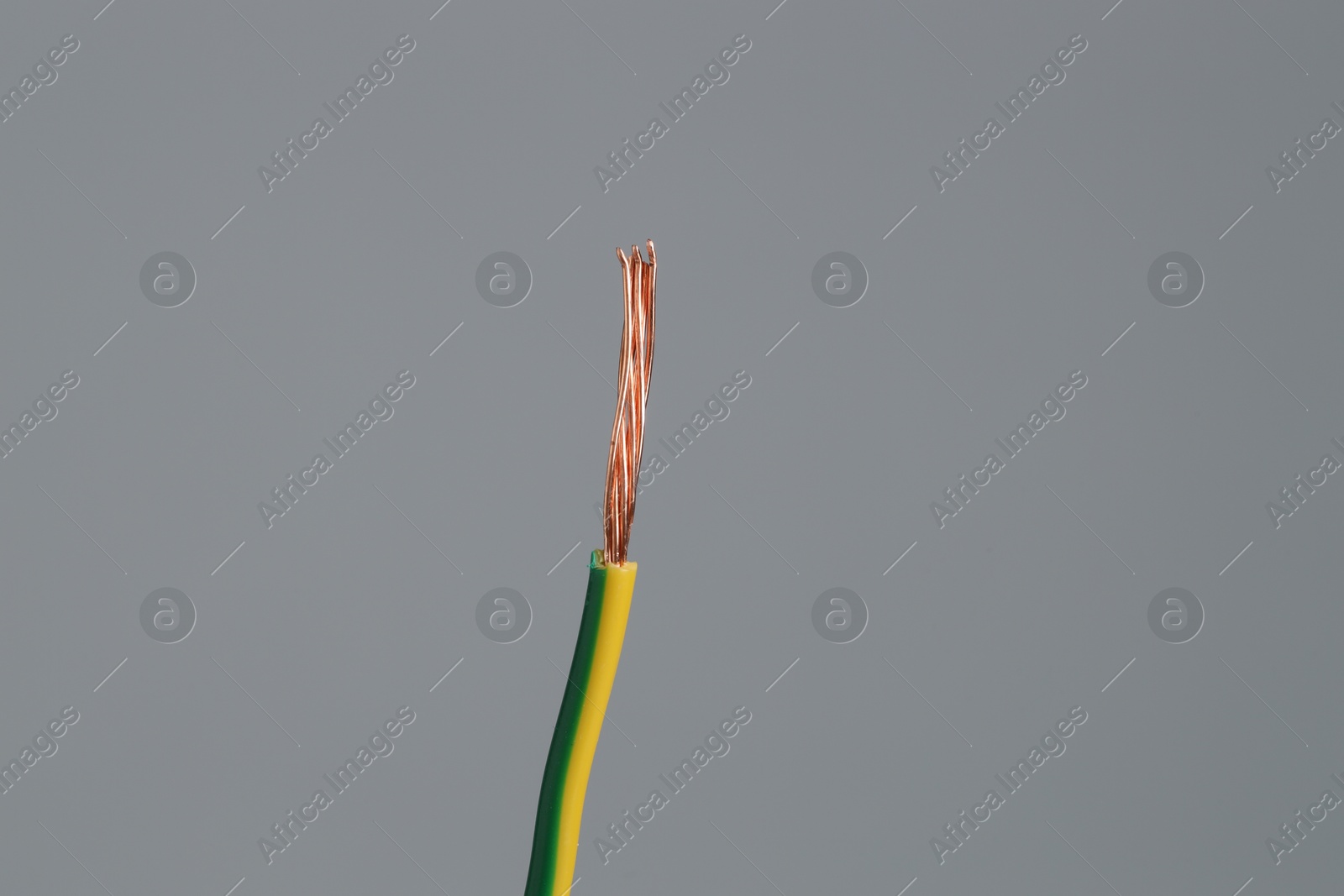 Photo of Stripped electrical wire on light grey background, closeup