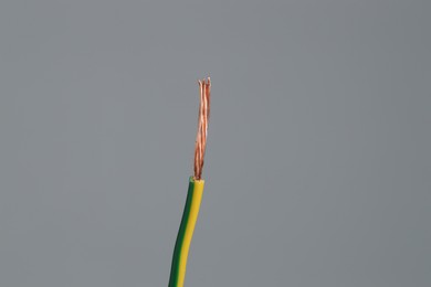 Photo of Stripped electrical wire on light grey background, closeup