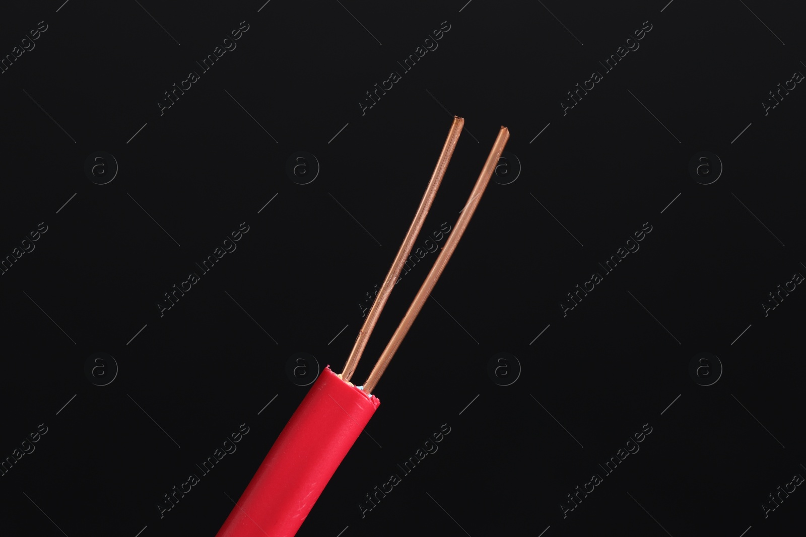 Photo of Red stripped electrical wire on black background, closeup