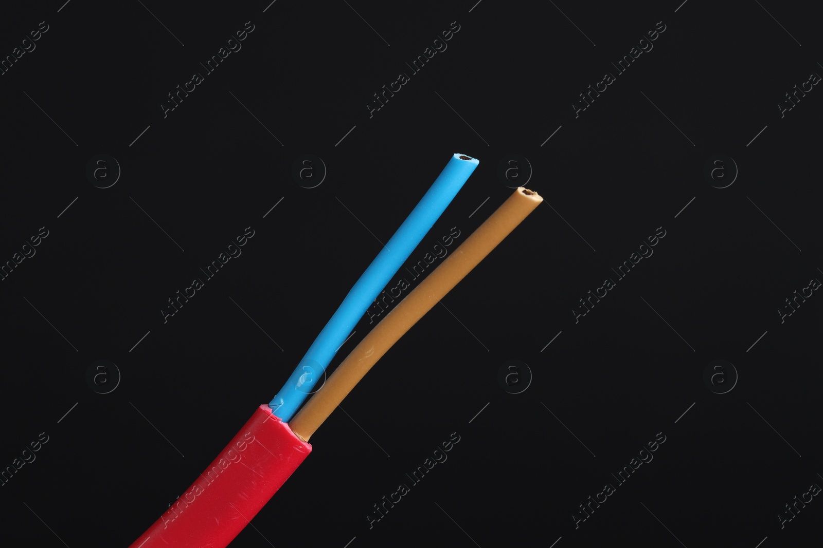 Photo of Red stripped electrical wire on black background, closeup