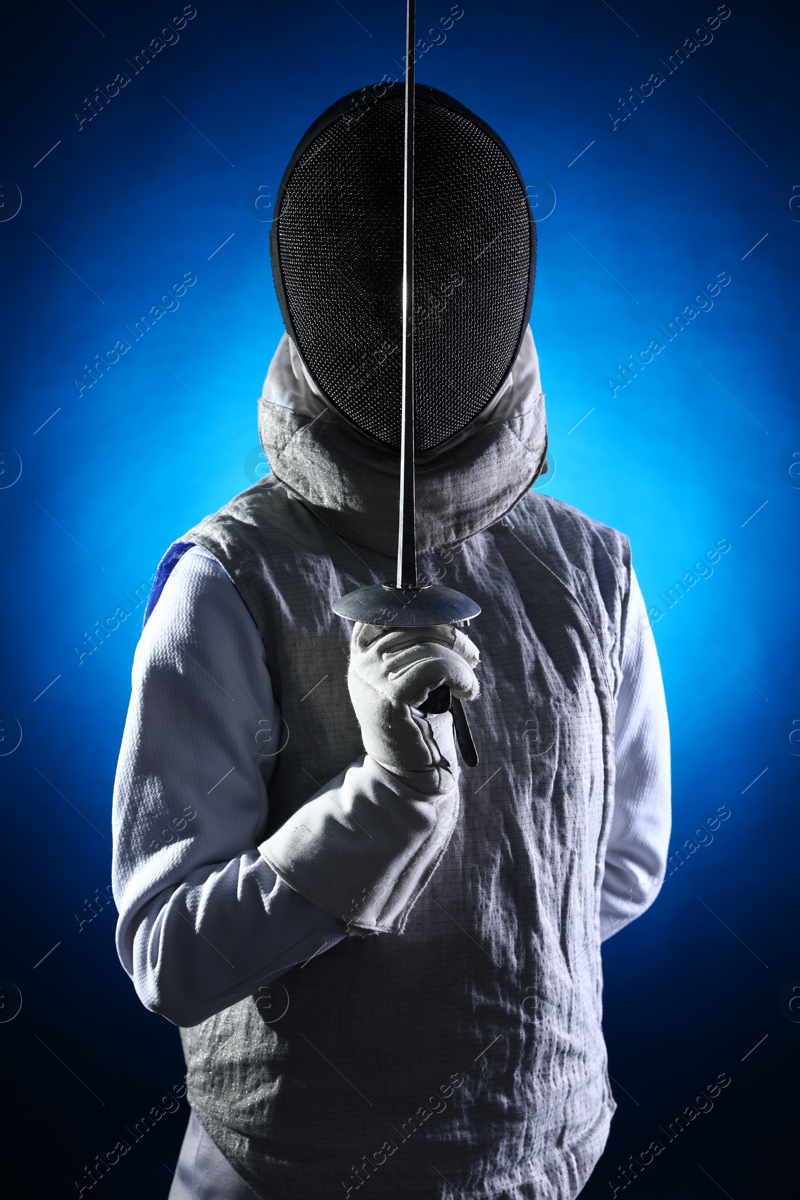 Photo of Fencer with epee on dark blue background