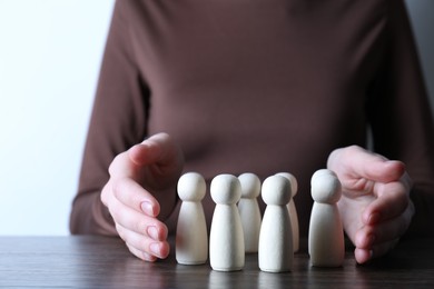 Photo of Human resources concept. Woman with wooden pieces at table, closeup