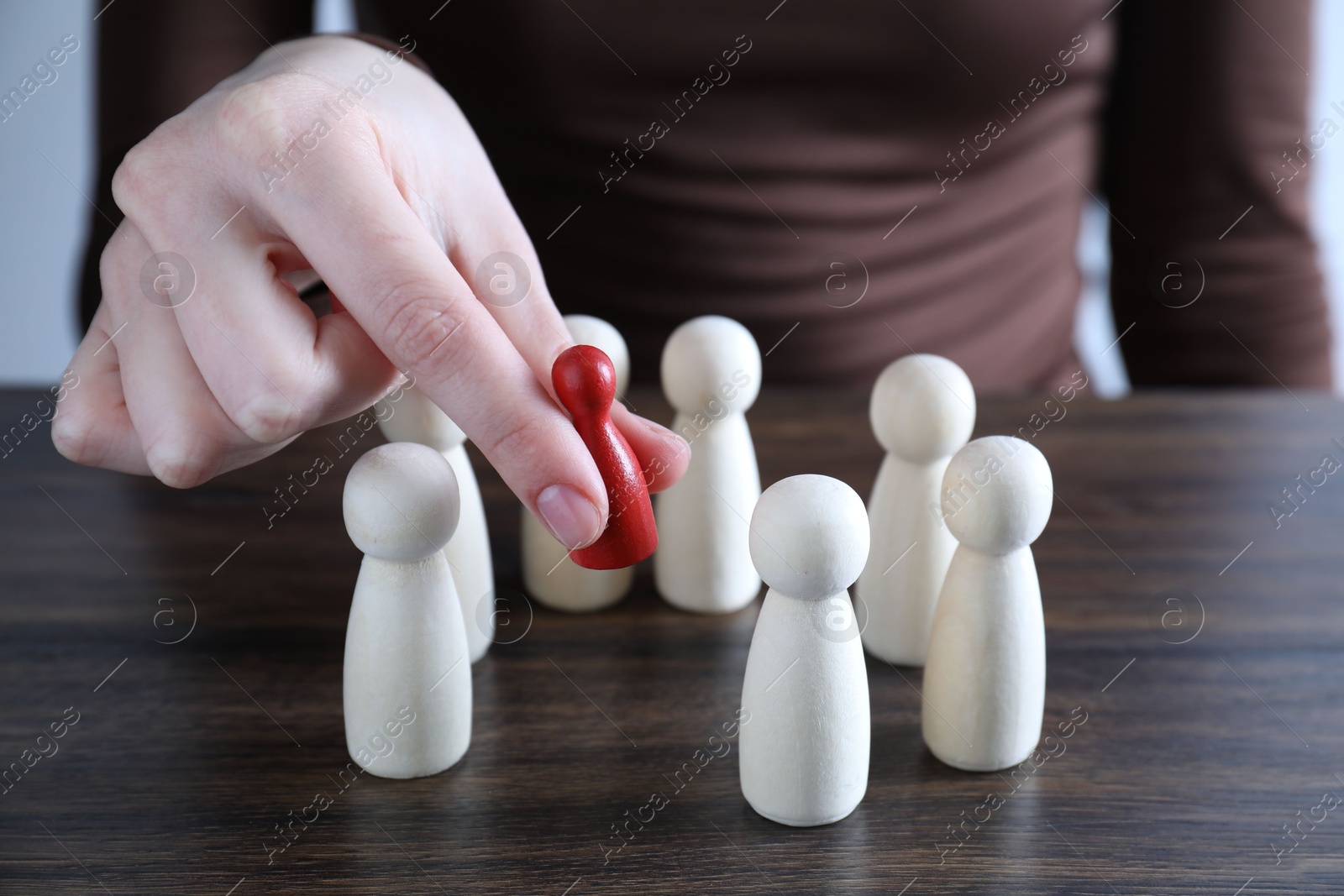 Photo of Human resources concept. Woman choosing red piece between other ones at table, closeup