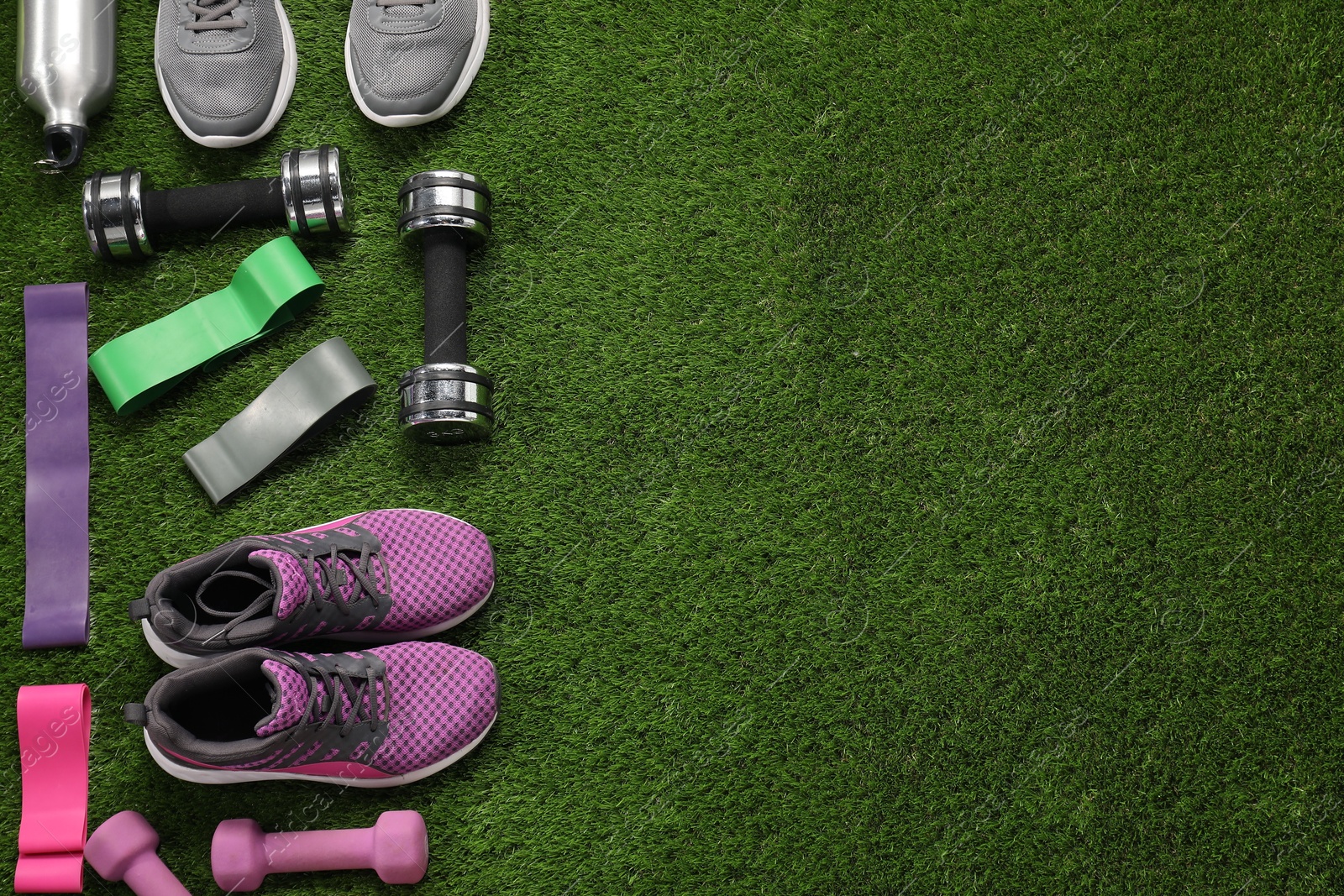 Photo of Different sport equipment on artificial grass, flat lay. Space for text