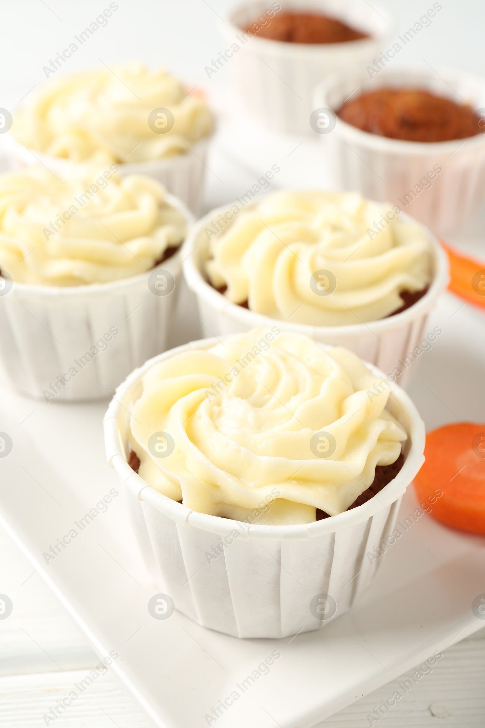 Photo of Tasty carrot muffins on white table, closeup