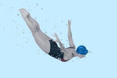 Woman wearing swimsuit swimming in water. Aquatic sport