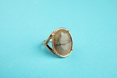 Beautiful bijouterie. Stylish ring on light blue background, closeup