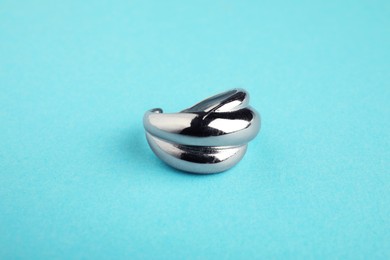 Beautiful bijouterie. Stylish ring on light blue background, closeup