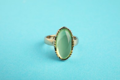 Beautiful bijouterie. Stylish ring on light blue background, closeup