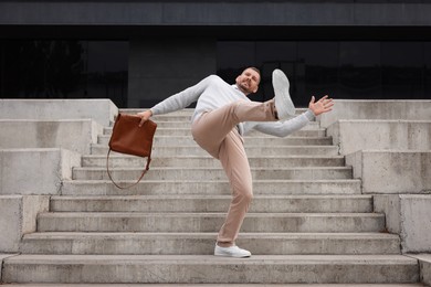 Photo of Man falling on stairs outdoors. Dangerous accident