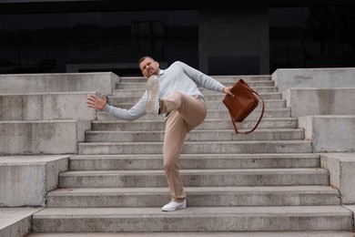 Photo of Man falling on stairs outdoors. Dangerous accident