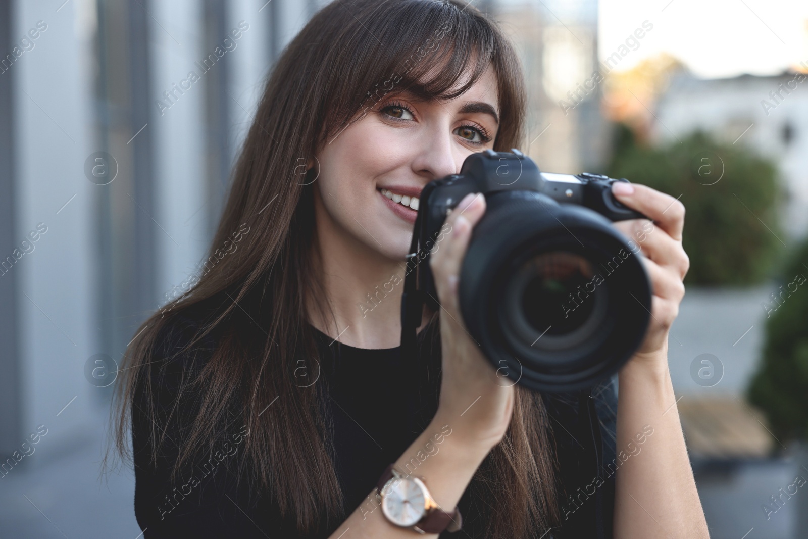 Photo of Professional photographer taking picture with camera outdoors