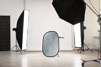 Photo of Professional lighting equipment setup in modern photo studio