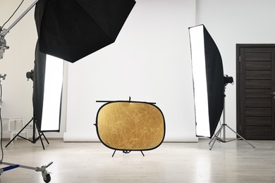 Photo of Professional lighting equipment setup in modern photo studio