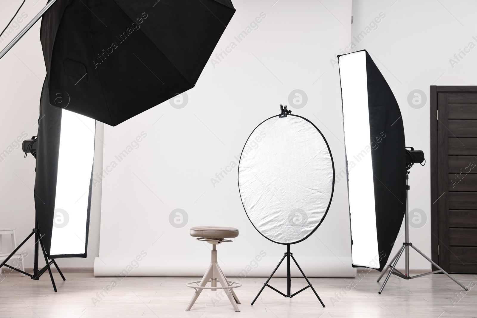 Photo of Professional lighting equipment setup in modern photo studio