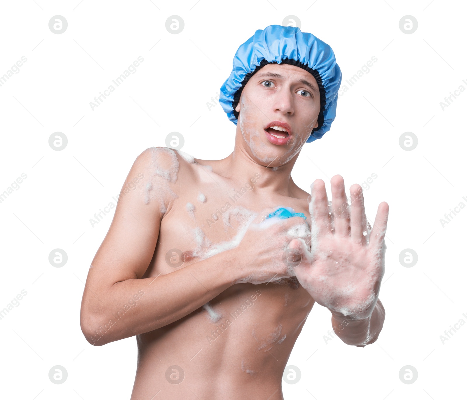 Photo of Man with shower cap and mesh sponge making stop gesture on white background