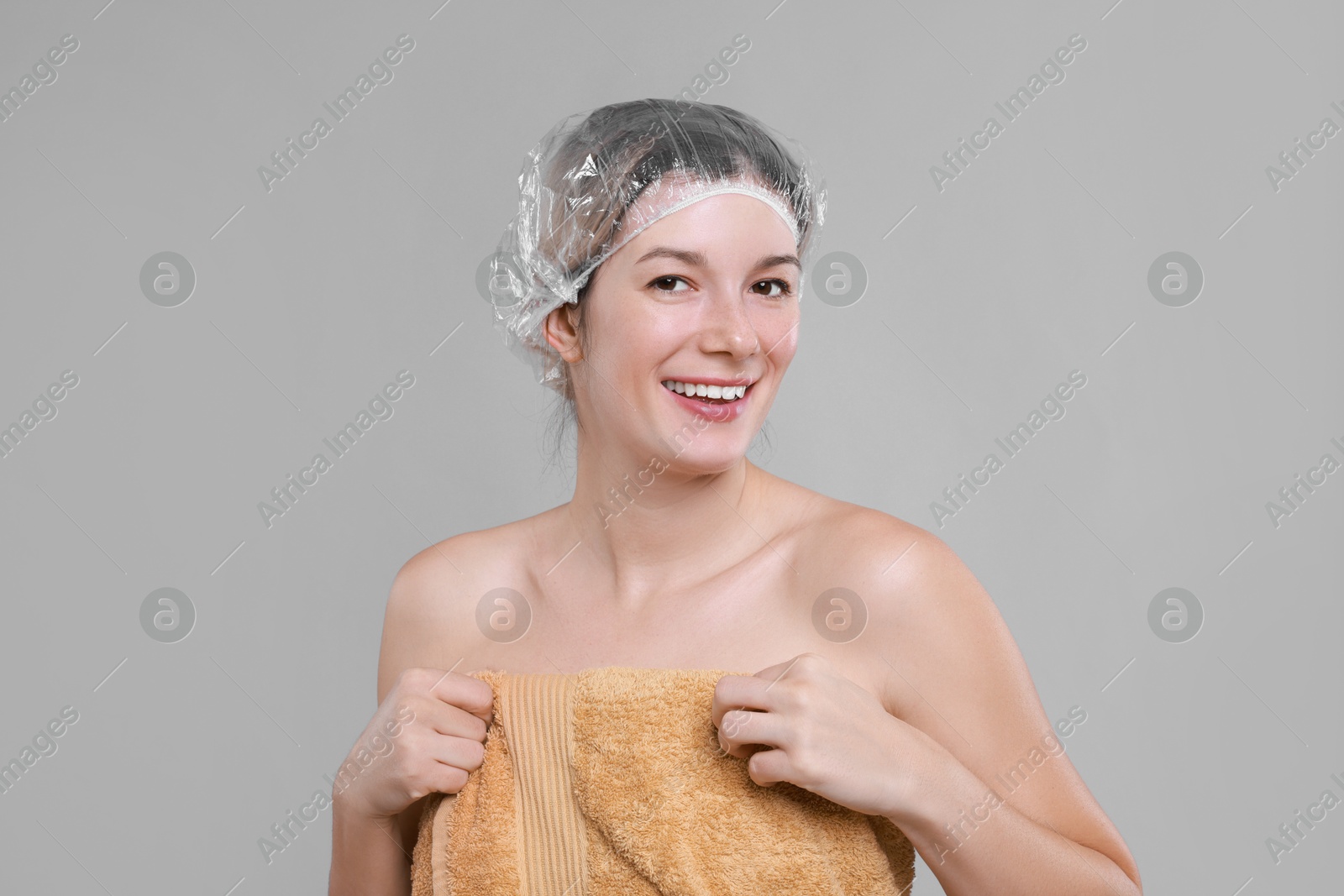 Photo of Woman in shower cap on grey background