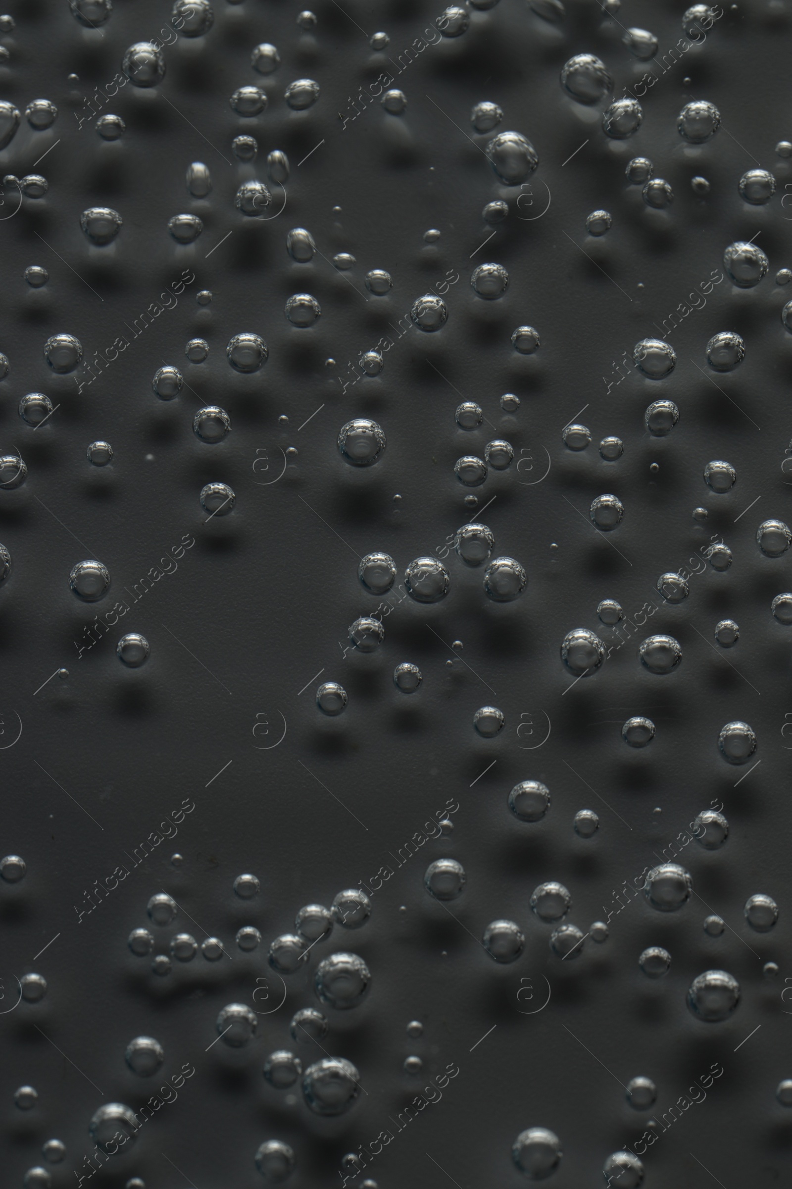 Photo of Soda water with bubbles of gas in glass, closeup