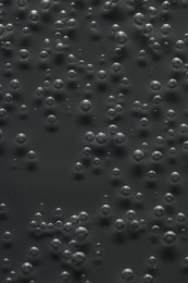 Photo of Soda water with bubbles of gas in glass, closeup