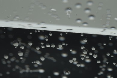 Soda water with bubbles of gas in glass, closeup