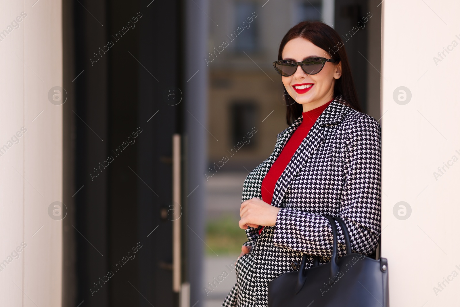 Photo of Beautiful woman in stylish suit outdoors. Space for text