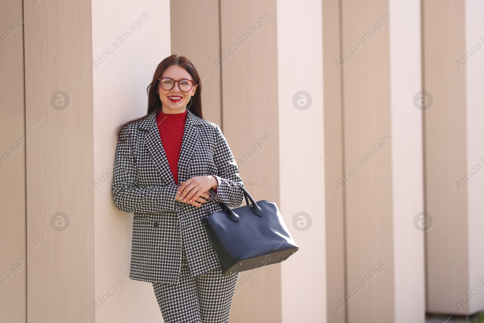 Photo of Smiling businesswoman in stylish suit outdoors on sunny day. Space for text