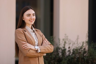 Photo of Beautiful woman in stylish suit outdoors. Space for text