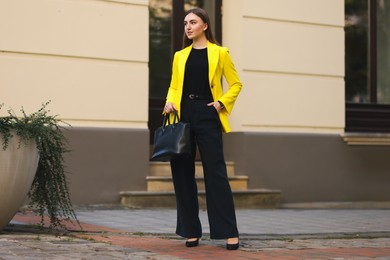 Photo of Beautiful businesswoman in stylish suit on city street