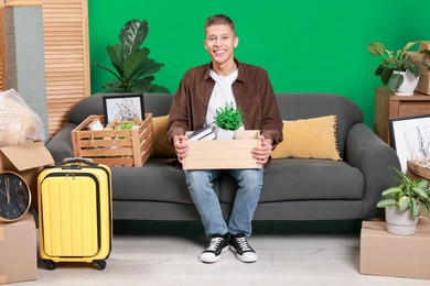 Photo of Happy man with different stuff in new apartment. Housewarming party