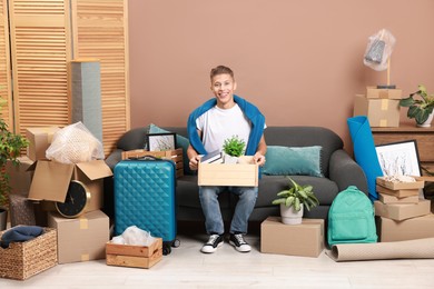 Photo of Happy man with different stuff in new apartment. Housewarming party