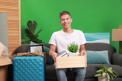 Photo of Happy man with different stuff in new apartment. Housewarming party