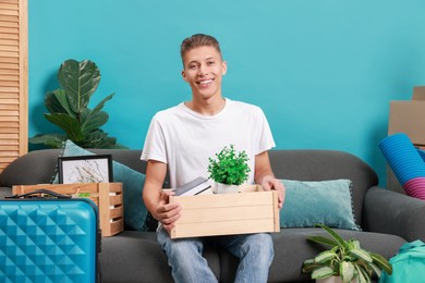 Photo of Happy man with different stuff in new apartment. Housewarming party