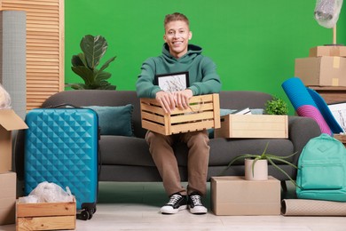 Photo of Happy man with different stuff in new apartment. Housewarming party