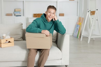 Photo of Happy man with moving boxes in new apartment. Housewarming party