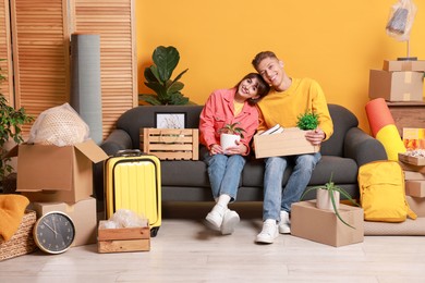 Photo of Happy couple with different stuff in new apartment. Housewarming party