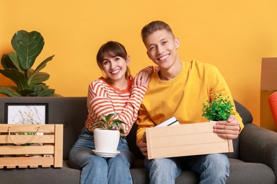 Photo of Happy couple with different stuff in new apartment. Housewarming party