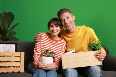 Happy couple with different stuff in new apartment. Housewarming party