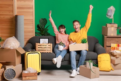 Photo of Happy couple with different stuff in new apartment. Housewarming party