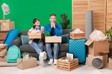 Photo of Happy couple with different stuff in new apartment. Housewarming party