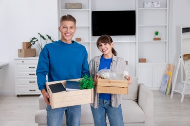 Photo of Happy couple with different stuff in new apartment. Housewarming party