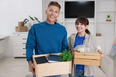 Photo of Happy couple with different stuff in new apartment. Housewarming party