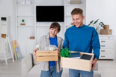 Photo of Happy couple with different stuff in new apartment. Housewarming party