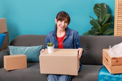 Photo of Happy woman with different stuff in new apartment. Housewarming party