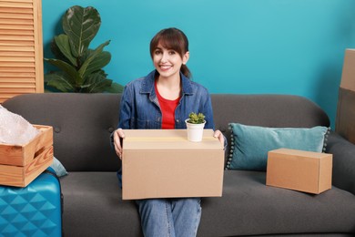 Photo of Happy woman with different stuff in new apartment. Housewarming party