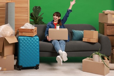 Photo of Happy woman with different stuff in new apartment. Housewarming party