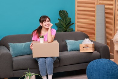 Photo of Happy woman with moving boxes in new apartment. Housewarming party