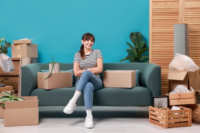 Photo of Happy woman with moving boxes in new apartment. Housewarming party