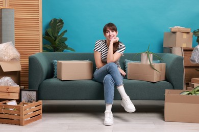 Photo of Happy woman with moving boxes in new apartment. Housewarming party